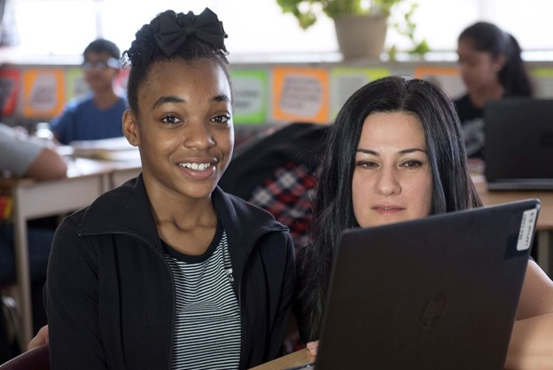 High school classroom with student working with laptop